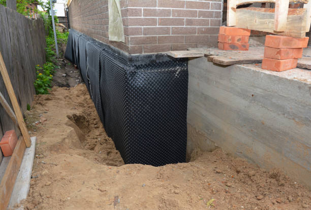 Happy homeowners after waterproofing job in Holmes